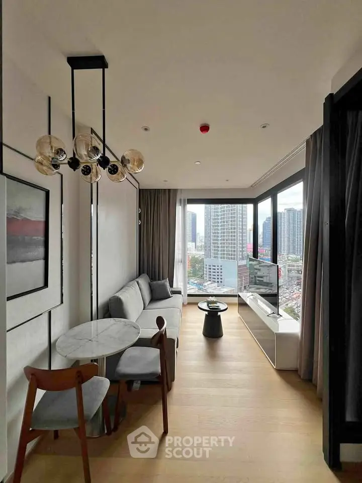 Modern living room with panoramic city view, stylish furniture, and elegant lighting in a high-rise apartment.