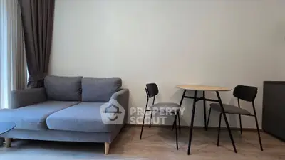 Modern living room with stylish gray sofa and minimalist dining set, perfect for cozy urban living.