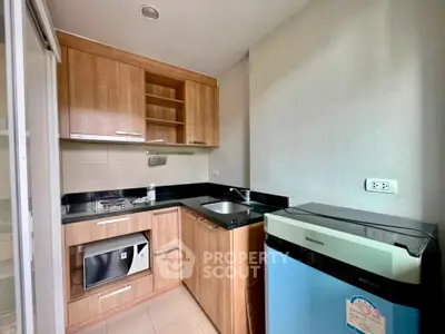 Modern compact kitchen with wooden cabinets and appliances