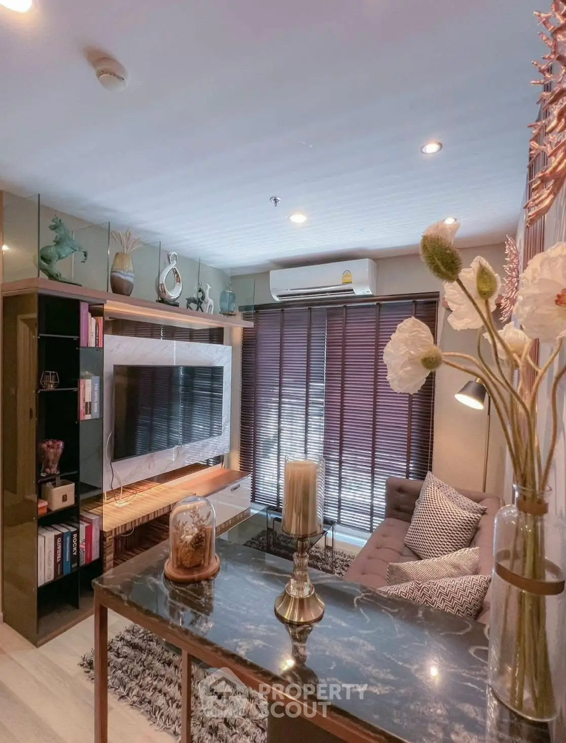 Stylish living room with modern decor, cozy sofa, and wall-mounted TV, perfect for relaxation and entertainment.