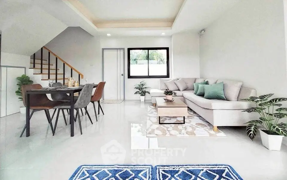 Modern living room with stylish furniture and dining area, featuring elegant decor and natural light.