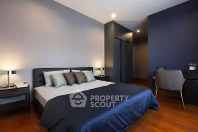 Modern bedroom with stylish decor and cozy ambiance, featuring a comfortable bed and sleek furniture.