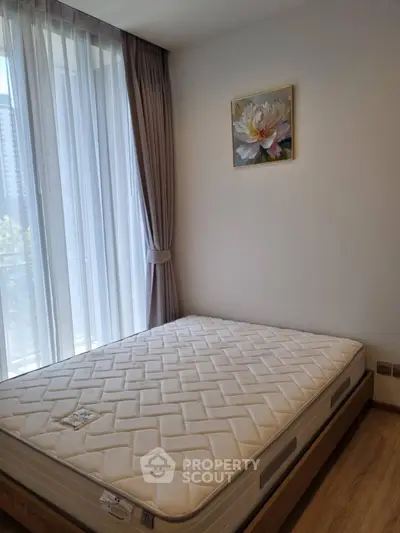 Bright bedroom with large window and modern decor