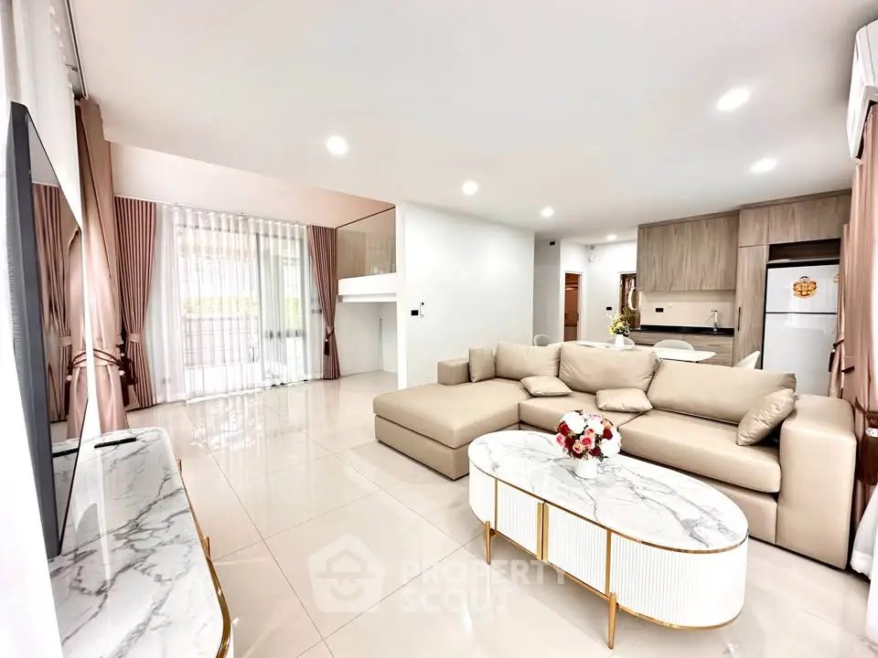 Spacious modern living room with elegant beige sofa and marble coffee table