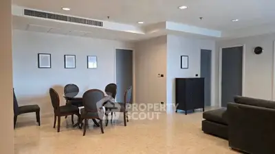 Spacious modern living room with elegant dining area and stylish furniture.