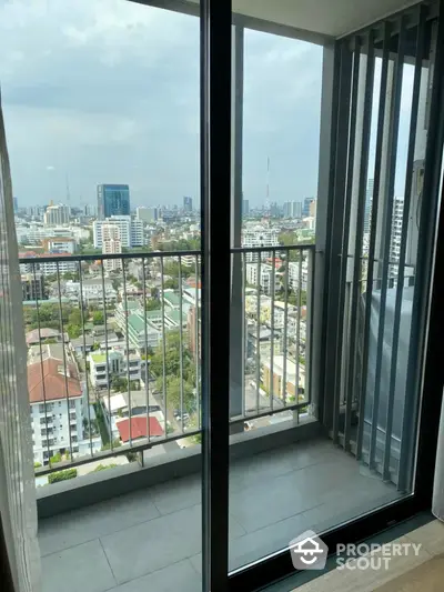 Stunning cityscape view from modern apartment balcony with sleek railing design.