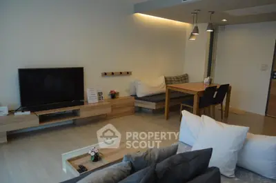 Modern living room with cozy seating and stylish decor in a contemporary apartment.