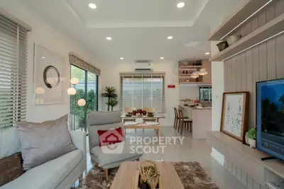 Modern living room with open layout and stylish decor, featuring cozy seating and elegant dining area.