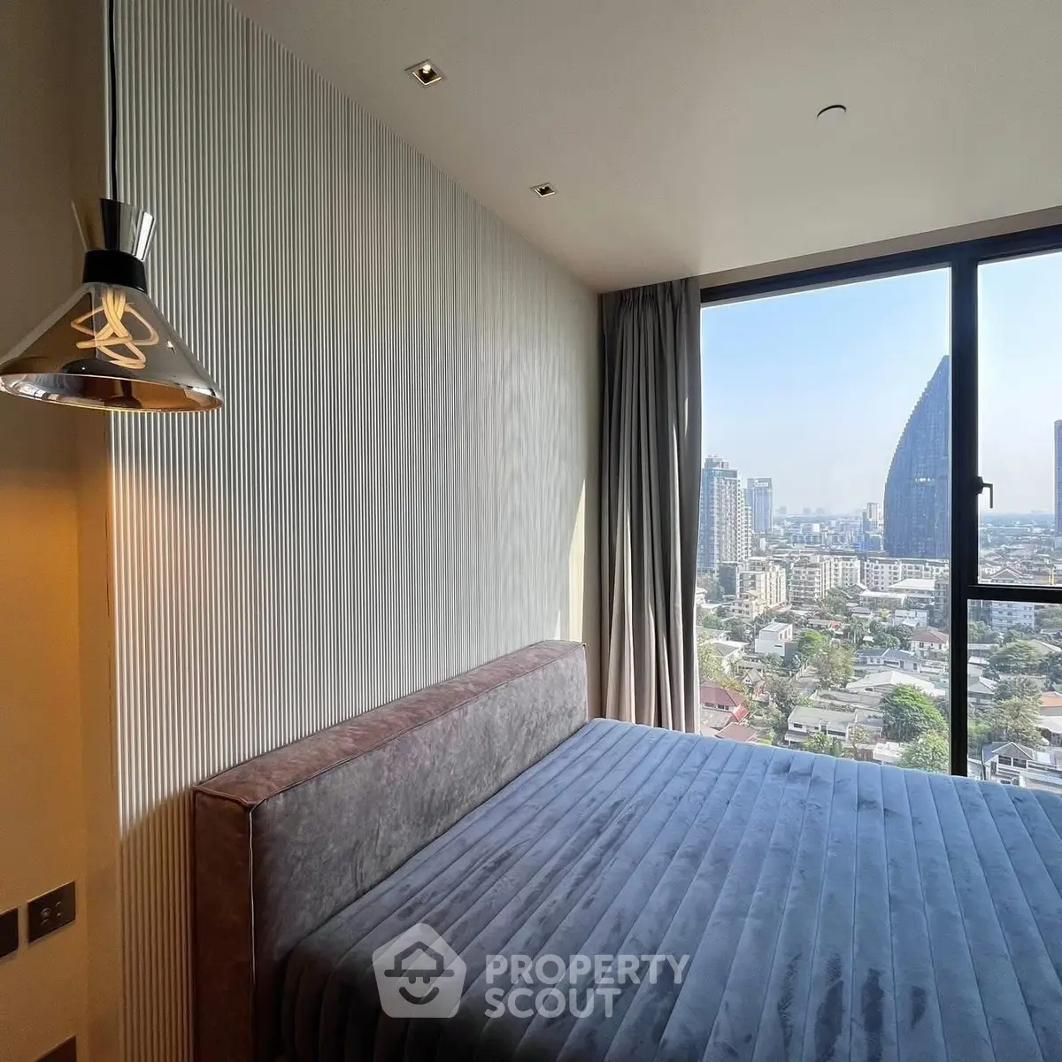 Luxurious bedroom with stunning city view and modern decor in high-rise apartment