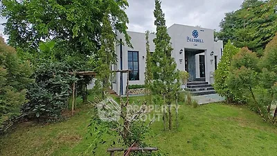 Charming modern building surrounded by lush greenery, perfect for serene living.