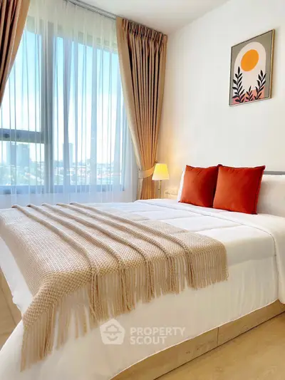 Bright and cozy bedroom with large window and stylish decor