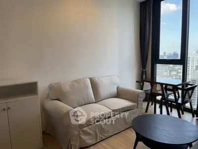 Modern living room with cozy sofa and city view from large window