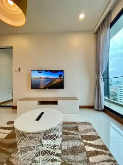 Modern living room with city view, stylish decor, and large windows.