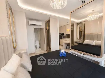 Luxurious modern bedroom with elegant decor and ensuite bathroom in a stylish apartment.