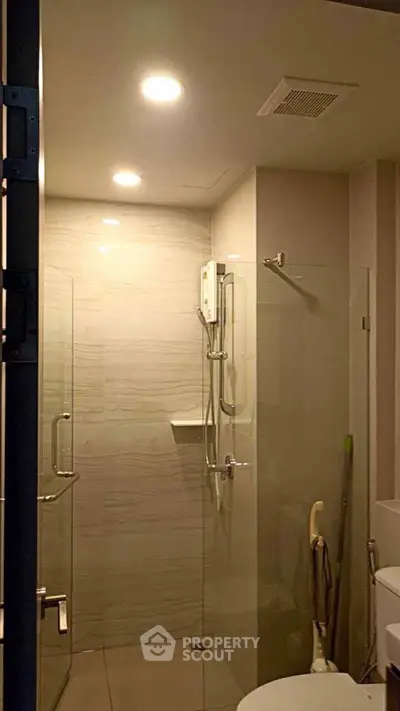 Modern bathroom with glass shower enclosure and sleek fixtures