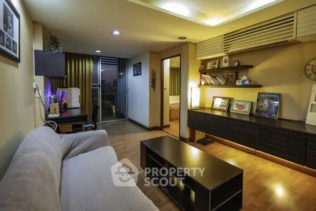 Stylish living room with modern decor and cozy ambiance in urban apartment.