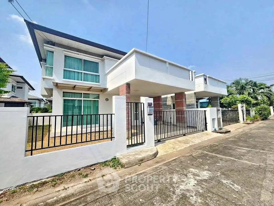 Modern two-story house with sleek design and spacious driveway in a serene neighborhood.