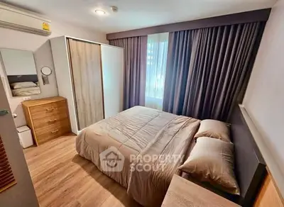 Cozy bedroom with modern furnishings and ample natural light