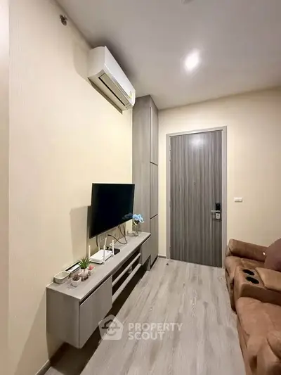 Modern living room with sleek TV unit and cozy seating