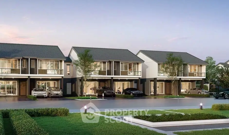 Modern suburban homes with driveways and landscaped gardens at sunset.