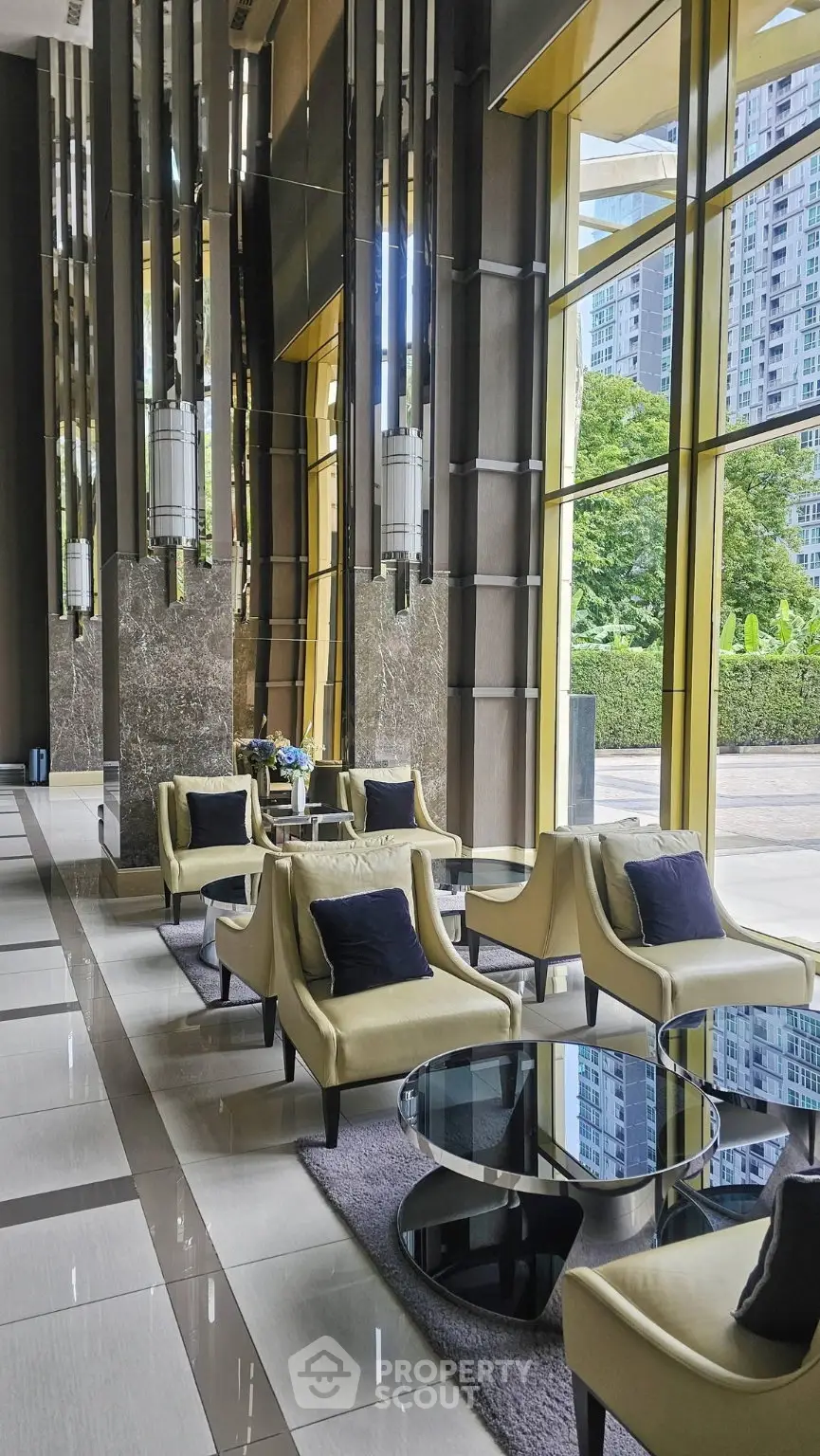 Luxurious lobby with modern seating and floor-to-ceiling windows offering stunning views of the cityscape.