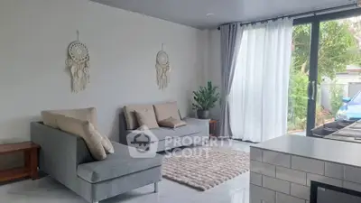 Modern living room with stylish decor and large windows overlooking a garden, featuring cozy seating and elegant design.