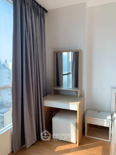 Bright bedroom corner with vanity table and large window in modern apartment.