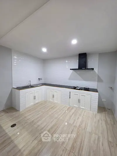 Modern kitchen with sleek design and gas stove in a bright, spacious layout.