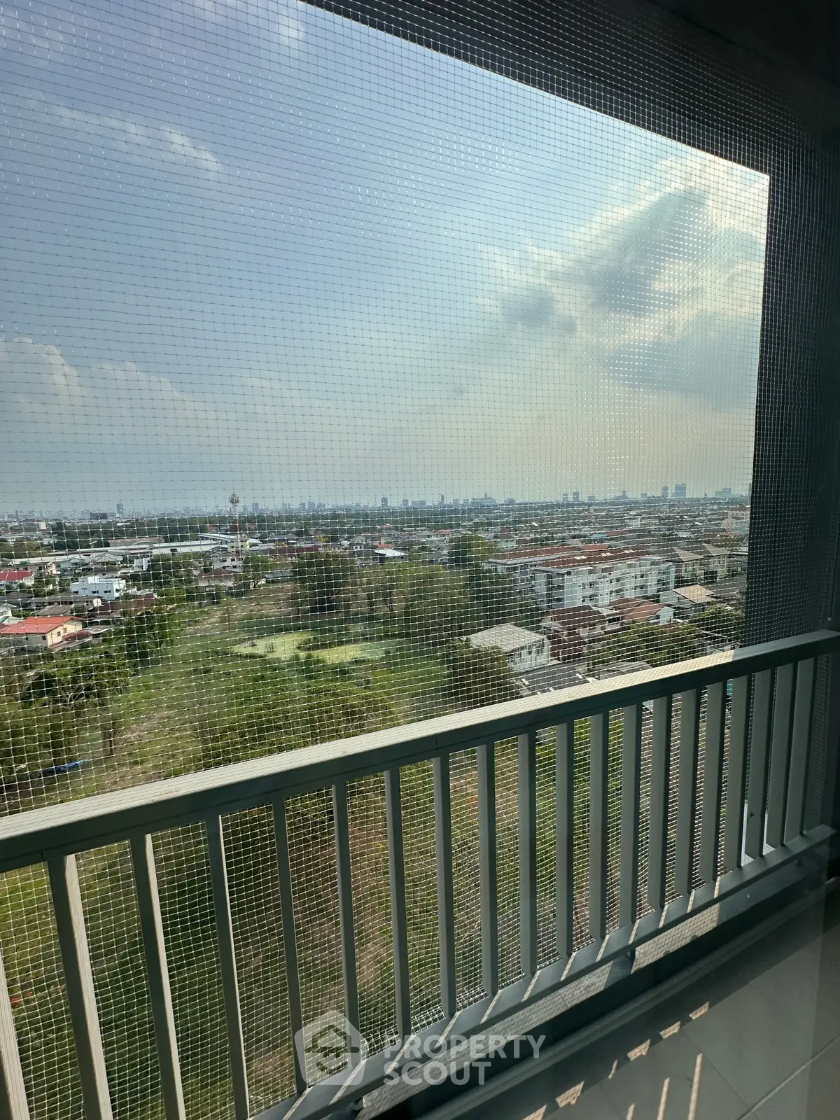 Stunning balcony view overlooking cityscape and greenery, perfect for relaxation.