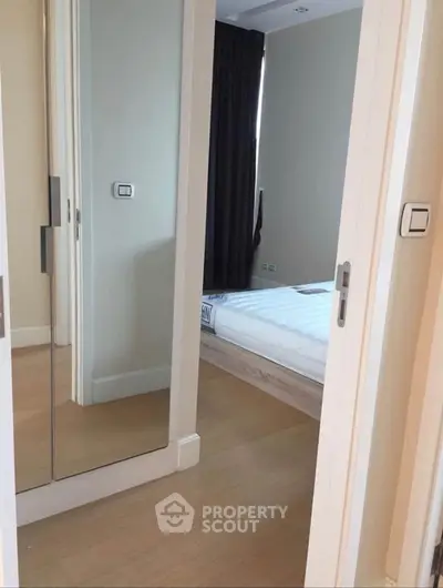 Modern bedroom with mirrored closet doors and sleek design