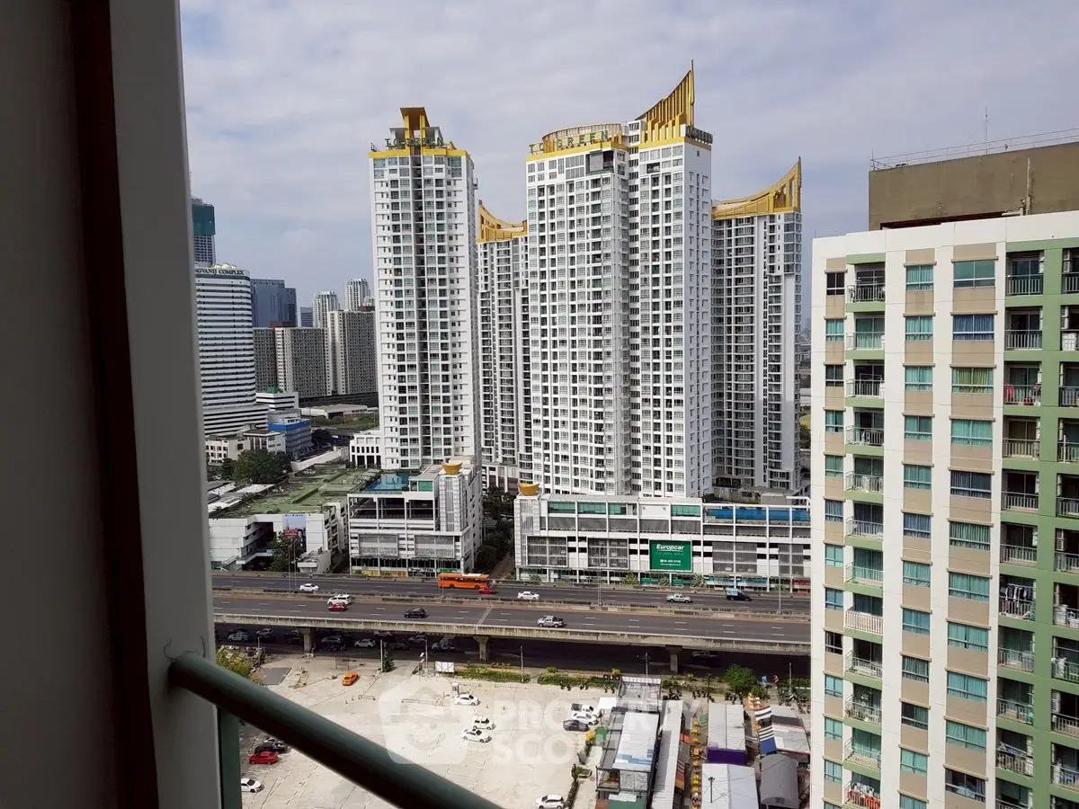 Stunning cityscape view from a high-rise balcony showcasing modern skyscrapers and urban skyline.