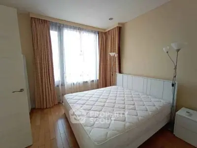Spacious bedroom with large window and elegant curtains in modern apartment