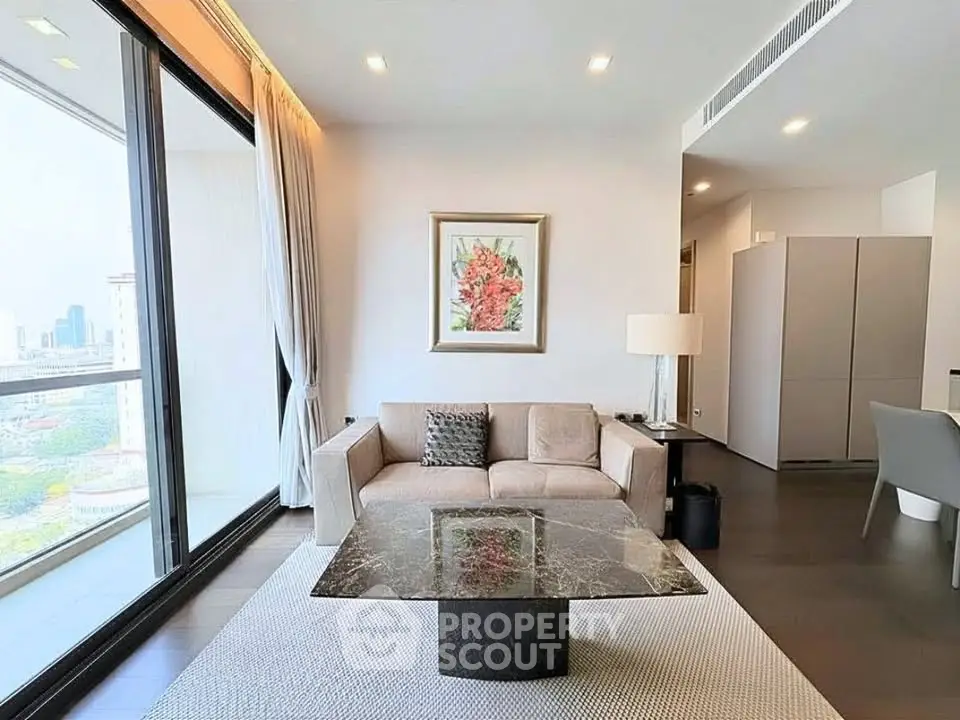 Modern living room with large windows and city view, featuring elegant decor and a marble coffee table.