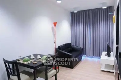 Modern living room with cozy seating and dining area, featuring sleek furniture and ambient lighting.