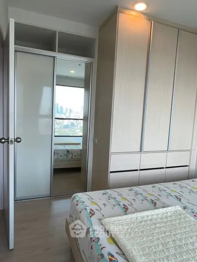Modern bedroom with city view, spacious wardrobe, and stylish decor