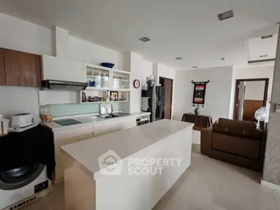 Modern kitchen with island and open layout in stylish apartment