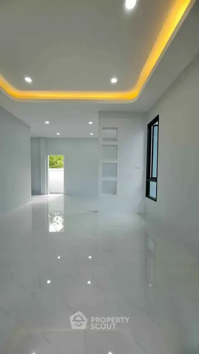 Spacious modern living room with elegant lighting and glossy marble floors.