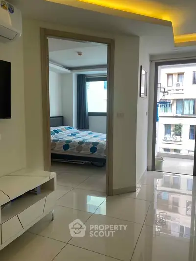 Modern apartment interior with sleek design, featuring a bedroom and living area with large windows and glossy floors.