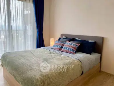 Cozy bedroom with stylish decor and large window for natural light