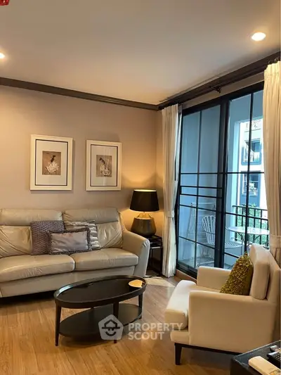 Cozy living room with elegant decor and balcony view, featuring comfortable seating and stylish lighting.
