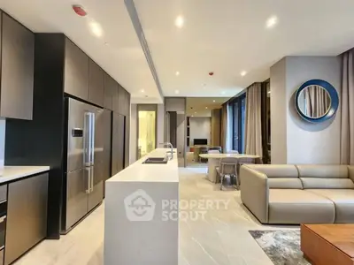 Luxurious modern living room with open kitchen, sleek furniture, and elegant lighting in a contemporary apartment.