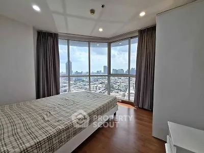 Spacious bedroom with panoramic city view and modern decor