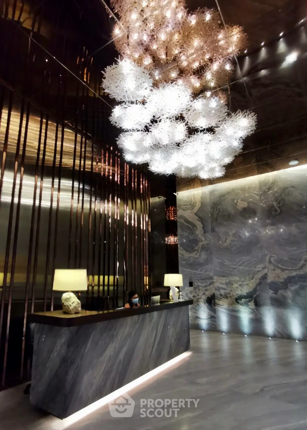 Luxurious modern lobby with stunning chandelier and elegant marble accents