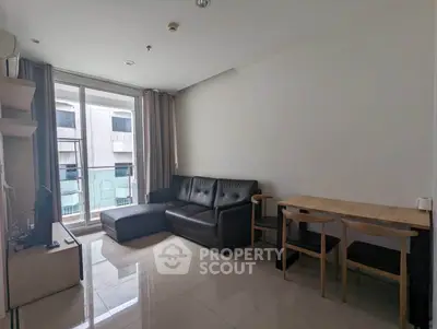 Modern living room with sleek furniture and large windows in a contemporary apartment.