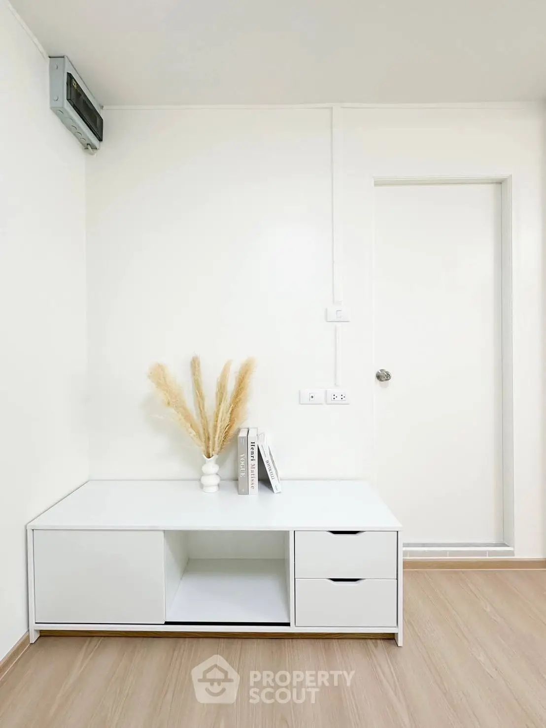Minimalist interior with white cabinet and decorative vase in modern apartment