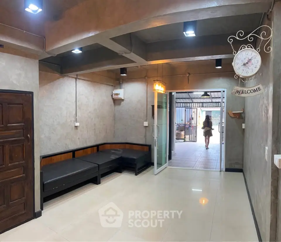 Spacious interior with modern lighting and open entrance, ideal for versatile use.