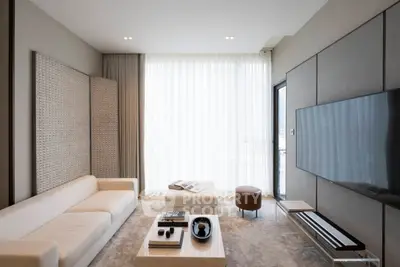 Luxurious modern living room with elegant decor and large flat-screen TV, perfect for relaxation and entertainment.