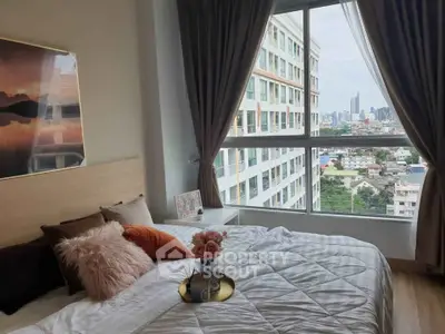 Modern bedroom with city view in high-rise apartment, featuring stylish decor and large windows.