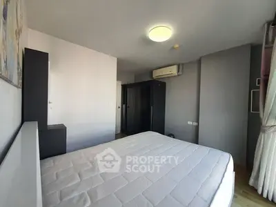 Spacious bedroom with modern furnishings and ample natural light