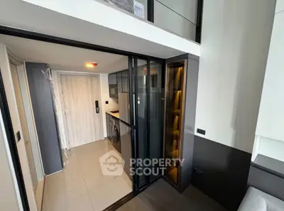Modern apartment interior with sleek kitchen and laundry area
